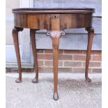 A Georgian walnut semicircular fold-over tea table with double action top, on cabriole supports