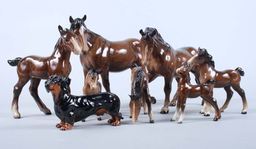 A Beswick horse, a dachshund and a number of similar foals (some a/f)