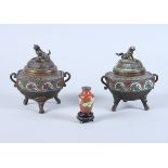 A pair of early 20th century Japanese bronze and cloisonne censers with covers, on splay supports