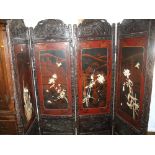 A late 19th century Chinese red and black lacquered four-panel floor screen, inlaid with birds and