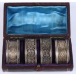 Two pairs of Victorian silver napkin rings, 2.4oz troy approx, in fitted leather and velvet lined