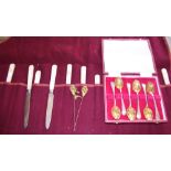 A set of six silver backed and mother-of-pearl handled knives and forks, together with a cased set