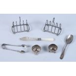 A pair of silver spiral fluted salts, a pair of silver wirework toast racks, a Georgian silver