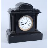 A 19th century slate mantel clock with white enamel dial and eight-day striking movement, 11" high