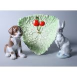 A Bing & Grondahl porcelain seated dog, a Lladro seated hare and a Carlton leaf moulded dish