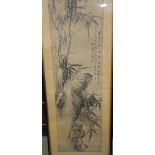 A Chinese ink drawing of a landscape with rocks and bamboo, 46 1/2" x 13", in strip frame