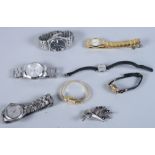 Seven lady's and gentleman's wristwatches and a white metal and purple paste brooch