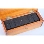 A set of mid 19th century bone and ebony dominoes, in a fitted mahogany box