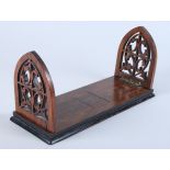A late Victorian walnut Gothic arched book slide, 12 1/2" long