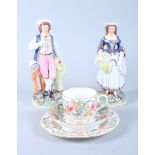 A late Victorian Staffordshire pottery model of a shepherd and shepherdess, 8 1/2" high, and a