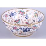 An early 20th century, possibly Booths, porcelain bowl, decorated with flowers and fruit, on a