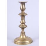 A late 18th century brass candlestick, 10" high