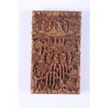 An early 20th century Chinese sandalwood card case, 4" long, carved with village scene (restored and