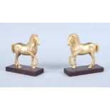 A pair of gilt bronze "San Marco" horses, on hardwood stands, 7" high