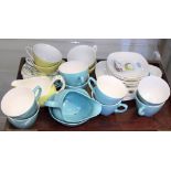Four mid 20th century Midwinter "Caribbean" pattern cups, saucers and a cream jug, together with a