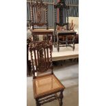 A pair of 19th century Charles II design oak occasional chairs with cane seat panels, and a