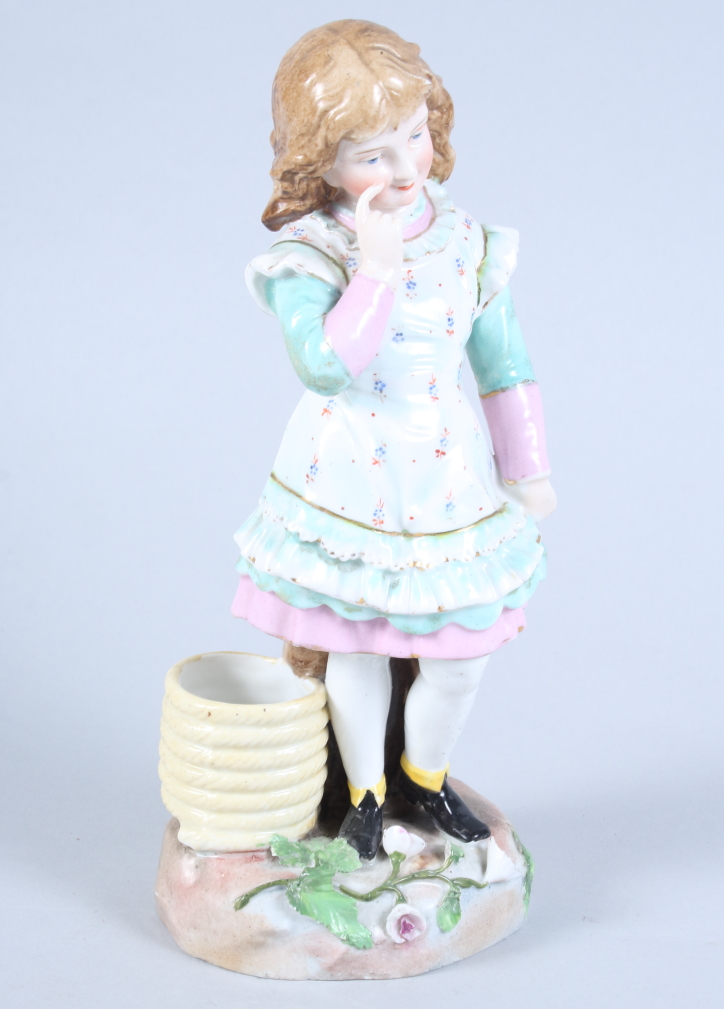 A late 19th century Continental porcelain figure of a girl standing by a coil of rope, 9 1/2"