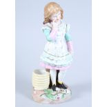 A late 19th century Continental porcelain figure of a girl standing by a coil of rope, 9 1/2"