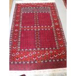 A Hatchli rug of traditional design in shades of red, blue, black and natural, 65" x 96" approx