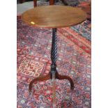 A 19th century wine table with oval oak top, on ebonised spiral fluted column and tripod base, 16" x