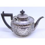 A late Victorian silver teapot with embossed floral and acanthus leaf decoration, composition handle