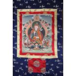 A Buddhist Tanka scroll, on fabric ground with protective cover, 42" x 29" overall