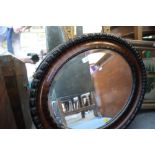 A mid 20th century oval mahogany wall mirror with an oil on board river scene with cattle