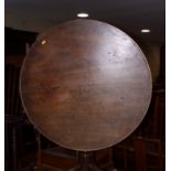 A George III mahogany circular tilt top table, on vase turned column and tripod splay support with