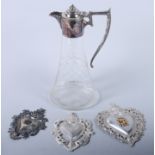 Three embossed Sacred Hearts, largest 6 1/2", and a claret jug with silver plated mounts