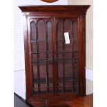 A 19th century mahogany display cabinet enclosed two doors over three drawers, 22" wide