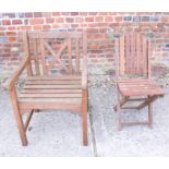 A teak slatted elbow chair and a folding garden chair