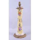 A late 19th century Continental porcelain table lamp, decorated floral sprays on a yellow ground,