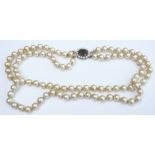 A 9ct gold and smoky quartz clasped two-strand faux pearl necklace