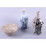 A Japanese pottery sake bottle with character decoration, 9 1/2" high, a provincial bowl and a
