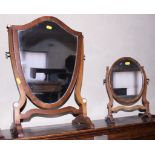 A late 19th century mahogany framed shield-shaped dressing table mirror, and a similar oval dressing