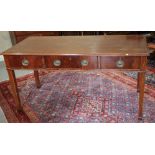 An early 19th century mahogany serving table, fitted three drawers, with oval brass handles and
