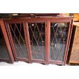 A mahogany bookcase enclosed three lattice doors, on bracket feet, 62" wide