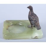 An Austrian cold painted bronze model of a red grouse, mounted on an onyx ashtray base