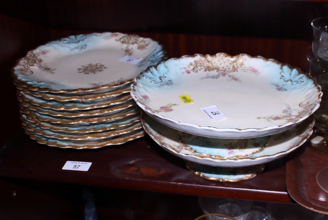 A Limoges porcelain part dessert service with floral and gilt highlighted borders