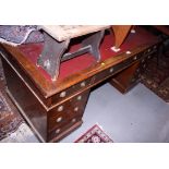 An early 20th century oak double pedestal desk, red lined top, fitted nine drawers, 60" wide