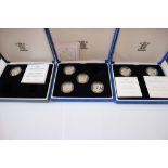 Five silver proof £1.00 coins and a £1.00 piedfort, in three fitted cases