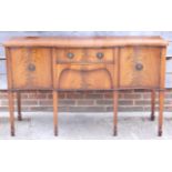 A late 19th century mahogany serpentine front sideboard, fitted two drawers and two cupboards, on