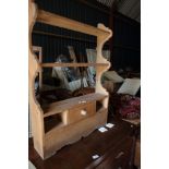 A waxed pine wall shelf, fitted cupboard and two recesses, 26 1/2" wide