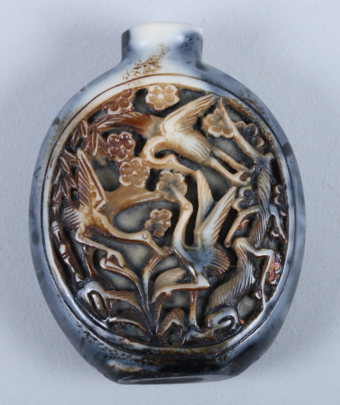 An early 20th century Chinese grey horn snuff bottle (stopper missing), incised carving with