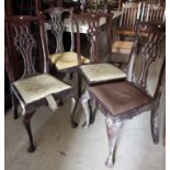 A set of four mahogany chairs of Chippendale design with pierced splat drop-in seats