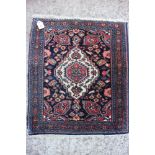A Persian mat with central white medallion on a blue ground and multi borders, 29" x 25" approx