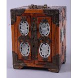 A miniature Chinese hardwood cabinet with brass mounts and green hardstone roundels, three drawers