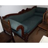 A late Victorian carved mahogany showframe scroll end settee, upholstered in a blue fabric, on