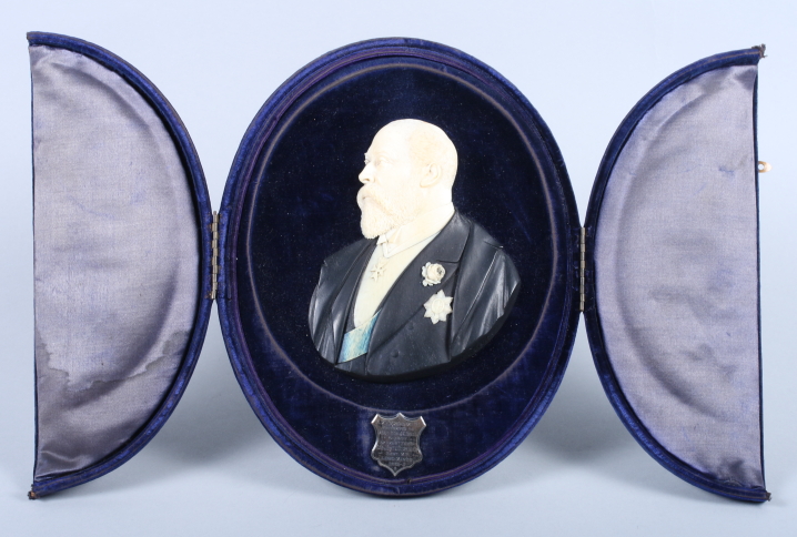 An early 20th century ebony and ivory relief portrait of Edward VII, signed W P Hogh, in a velvet