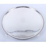 A George III silver salver with gadrooned border and central engraved coat of arms, 18 1/4" dia,